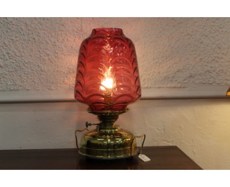 Victorian Veritas oil lamp converted to electric with large cranberry glass shade with brass reservoir, height 50 cm max diam