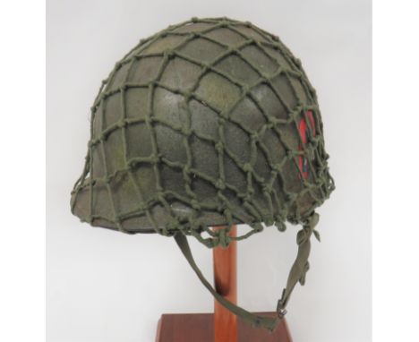Post November 1944 American M1 Helmetdark green, rough texture shell with spray areas of light green.  The left side with rem