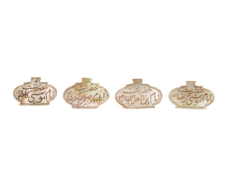 λ FOUR CARVED MOTHER-OF-PEARL TALISMANIC PENDANTS ENGRAVED WITH SHI'A IMAM NAMES  Collected in Lucknow, Awadh (Oudh), Norther