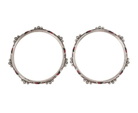 A PAIR OF TWO-TONE RED AND BLACK ENAMEL SILVER BANGLES Western Sahara or Mauritania, Africa, mid-20th centuryEach circular si