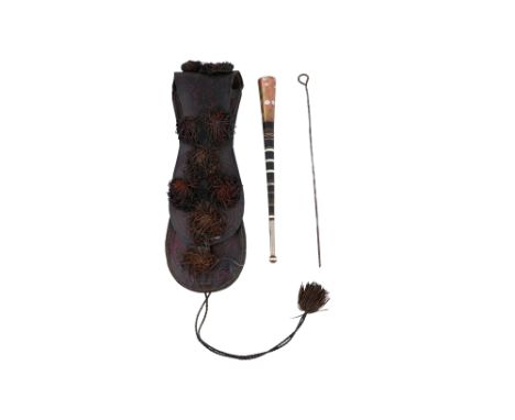 λ A PORTABLE TUAREG LEATHER CASE WITH SMOKING ACCESSORIES Northern Mali, Africa, first half 20th centuryOf flattened, elongat