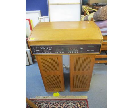 A Dynatron music centre housed in a teak case comprising a Garrard SP25 Mk IV record deck, Dynatron stereo recorder, and two 