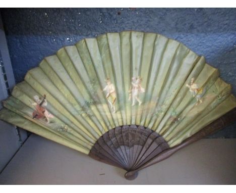 A 19th century French Brise fan, the wooden sticks and guards with carved floral decoration, the silk panel decorated with pu