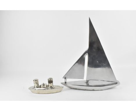 A Nauticalia of London polished aluminium model of a sailing yacht, 38cms high, 32.5cm long and an Art Deco chrome plated cru