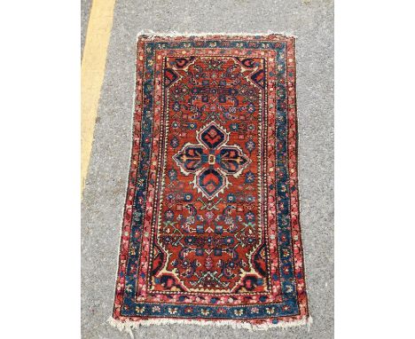 A vintage Zanjan rug with geometric design on a rouge ground 122 x 72cmLocation: 