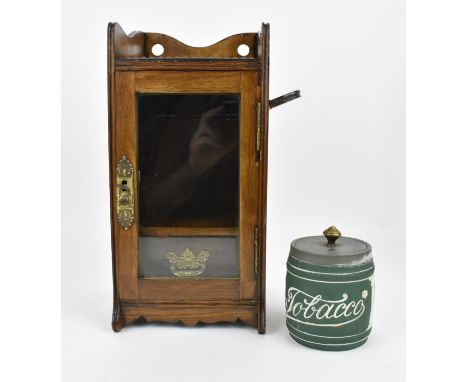 A late 19th century oak wall hanging smokers cabinet with gilt brass mounts, glazed door and interior drawer, with folding pi