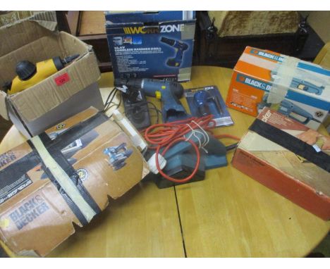 A boxed Work Zone 14.4v cordless hammer drill with right angle drill adaptor, a boxed Black & Decker 600w 75mm belt sander, a