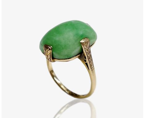 A 1920s jade ring set in 18ct yellow gold with four chased claws and finely pierced and engraved back gallery. Size K 7.2gm M