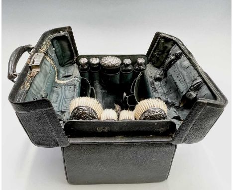 An Edwardian black leather toilet case with silver mounts hallmarked 1901 and 1902Condition report: The outside of the case i