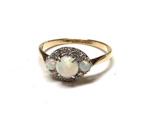 An 18ct gold and platinum navette ring set with three opals and diamonds. Size Q/R 2.8gmCondition report: Very good used cond