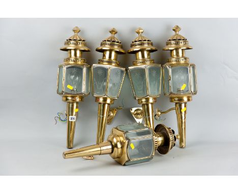 A group of five 20th Century brass electric carriage type lamps all with cut and bevelled edge segmented glass panels, two wi