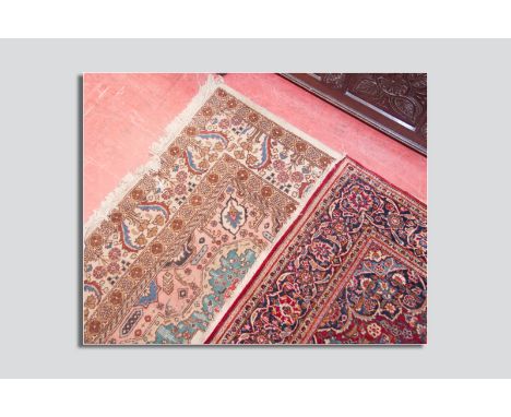 A light coloured woollen patterned carpet, 96 x 144 ins (244 x 366 cms) and a red ground woollen rug with multi-coloured patt