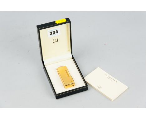 A nine carat gold plated Dunhill Swiss made cigarette lighter, no. 16714 complete in Dunhill box