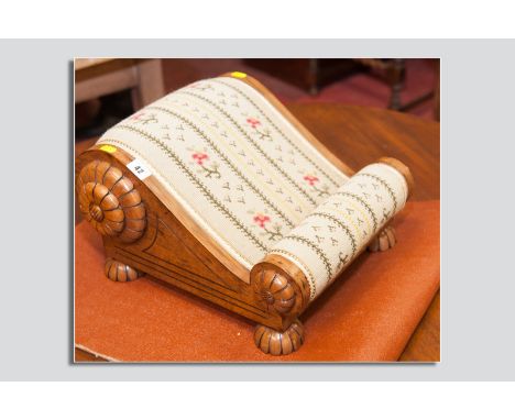 A nice quality modern mahogany footstool in the antique style, the shaped stool with applied petal carvings mirroring bun fee