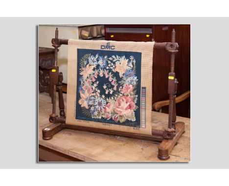 A Victorian wooden tapestry stretcher on turned columns and bun feet, 28.25 ins (71.5 cms) wide