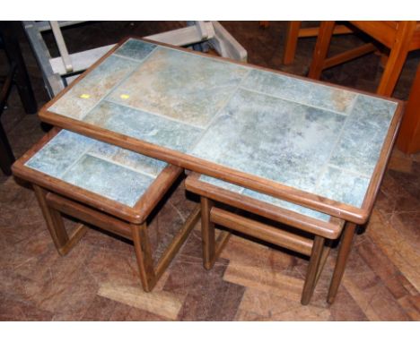 A nest of three teak tables inset with tile Condition reports are not available for our Interiors sales.