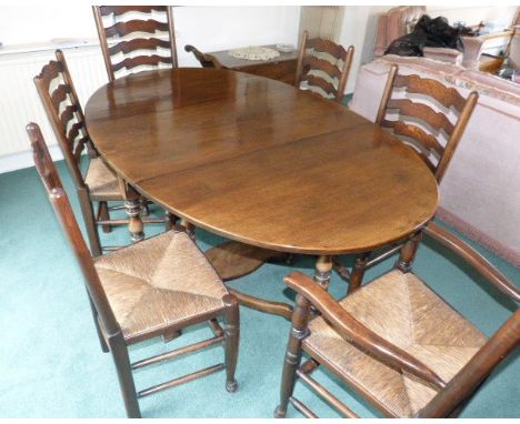 Reproduction oak oval gate-leg table and six rush-seated ladder-back chairs (2 carvers). Condition reports are not available 