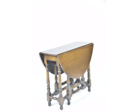 An 18th Century style oak drop leaf oval supper table, 20th CenturyThe oval top supported on ring turned bobbin shaped suppor