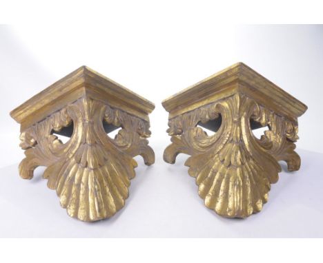 A pair of French Rococo style giltwood wall bracketsThe square flat top of each supported by scrolling carved and pierced aca