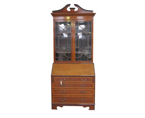 An Edwardian Sheraton Revival inlaid mahogany bureau bookcaseWith an inlaid twin swan neck pediment over a cross banded friez