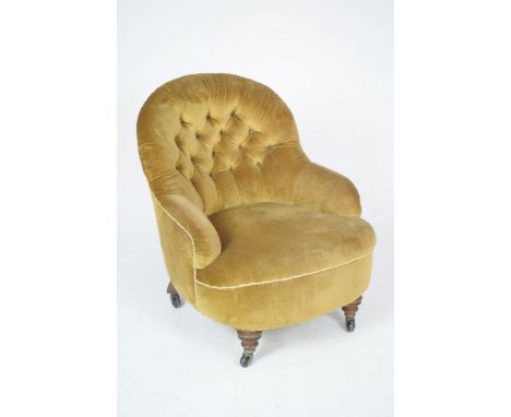 A Victorian velour tub chairThe arched button back above a sprung seat raised on front vase shaped legs and plain outset rear