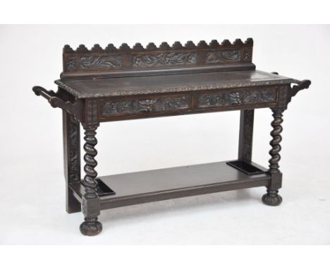 A Victorian carved oak hall tableThe scalloped raised back carved with flowers and scrolling leaves above a rectangular top w