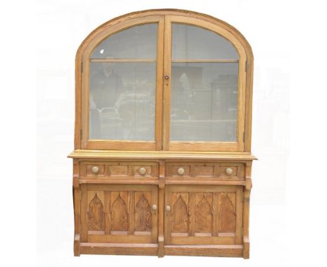 An unusual late Victorian Oregon pine dresserThe domed upper cabinet with two glazed doors enclosing a single shelf upon a ba