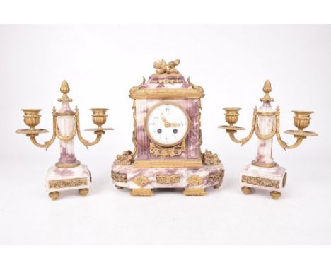 A French 19th Century marble 8-day clock garnitureThe architectural case with carved panels and gilt metal mounts, housing a 