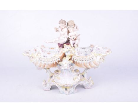 A Meissen style Dresden porcelain centrepiece, circa 1900The rocaille and shell moulded base, rising to a central stem, adorn