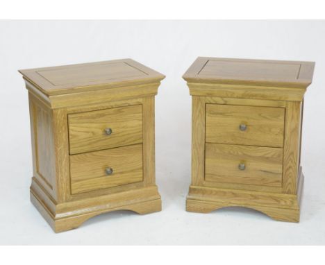 A pair of modern light oak bedside chestEach with a rectangular moulded top above two drawers with metal button handles raise