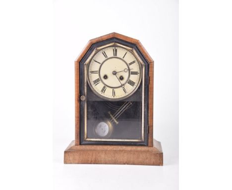 An early 20th Century eight-day mantel clock The arched architectural case with embossed beading, raised on a stepped base, t