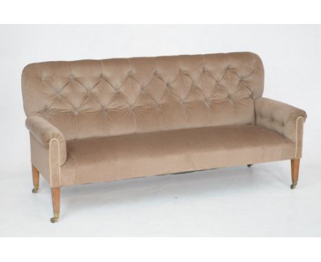 An Edwardian upholstered two seater setteeWith a  padded button back above padded scroll arms covered in brown velour and rai