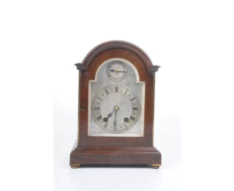 An early 20th Century Winterhalder and Hofmeier eight day mantel clock The arched architectural case with glazed arched door,