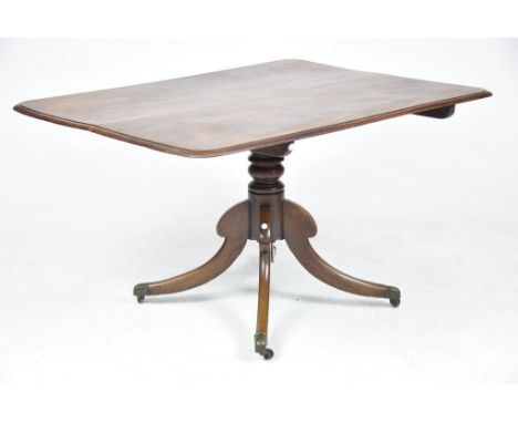 An early 19th Century mahogany tilt-top breakfast table The rectangular moulded top raised on a ring turned shaft and four do