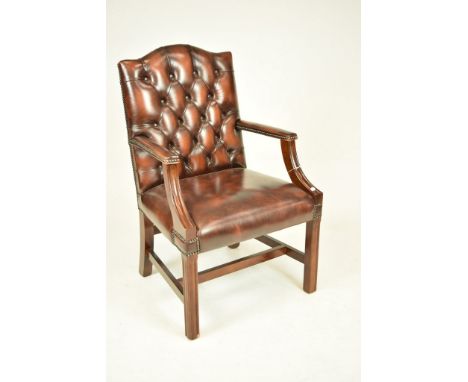 A Georgian style leather and mahogany open armchairThe button back above two padded arms on channelled down swept supports an