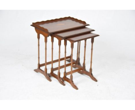 A nest of three Edwardian style mahogany tea tablesThe largest table with a galleried top and centered with an inlaid fan, ra
