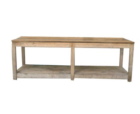 A rustic pine plank top work table With a rectangular six plank top supported on six substantial square section supports over