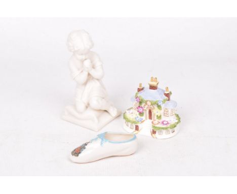A small group of collectable ceramicsTo include a W.H. Goss parian figure, 16cm high, a Coalport "Keepers Cottage" figure, an