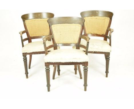 A set of three 19th Century Colonial walnut elbow chairsThe concave rails back above a padded back, stuff-over seats and out 