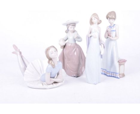 A collection of four Lladro figuresEach typically modelled with lady figures and ballerinas in muted pastel tones, size rangi