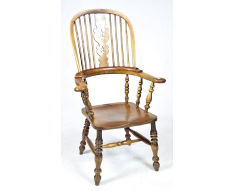 A 19th Century elm and beech wood Windsor farmhouse elbow chairThe hoop back with a central pierced splat above out swept arm