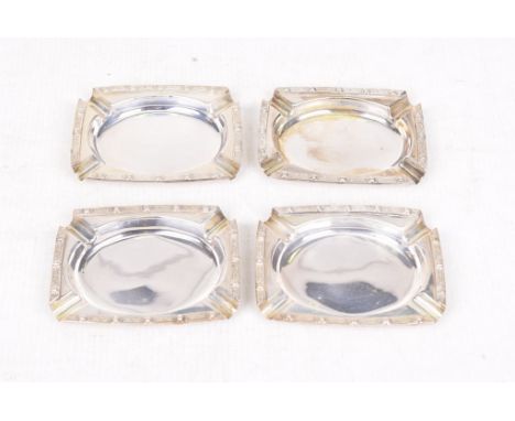 A set of four silver ash traysOf shaped rectangular form, with applied Celtic knot pattern rims, by David Lawrence, Birmingha