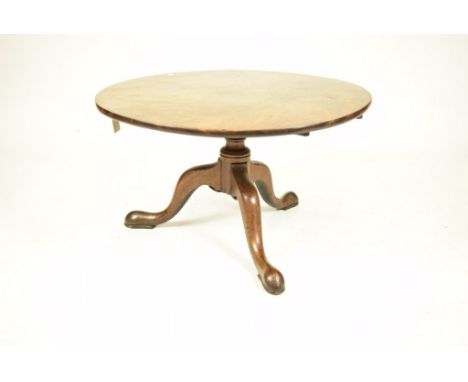 A George III mahogany tripod tableThe circular tilt top on a reduced ring turned shaft and three down swept supports with pad