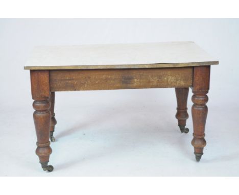 A 19th Century mahogany kitchen tableWith a later rectangular Formica top raised on ring turned baluster shape legs and casto