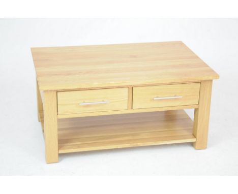 A modern light oak coffee tableWith a rectangular top above two pairs of opposing frieze drawers , each with brush metal bar 