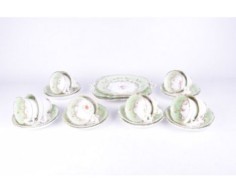 A Late 19th Century English porcelain tea serviceComprising twelve teacups, twelve saucers, two serving plates and cake plate