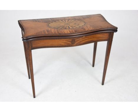A George III satinwood and inlaid Serpentine games tableThe hinged top centred with an oval inlaid fan enclosing a baize line
