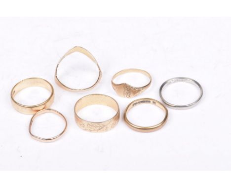 A collection of 9ct gold ringsTo include; two plain bands, a wishbone ring, an 18ct white gold band, with remaining rings (7)