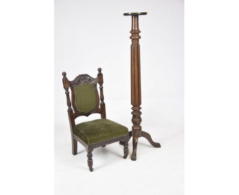 A late 19th Century mahogany torchere With a ring turned lobed and acanthus leaf column raised on three down swept supports a