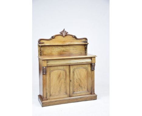 A 19th Century mahogany chiffonierThe raised back centred with a leafy crest above a Serpentine shelf supported on C-scroll b